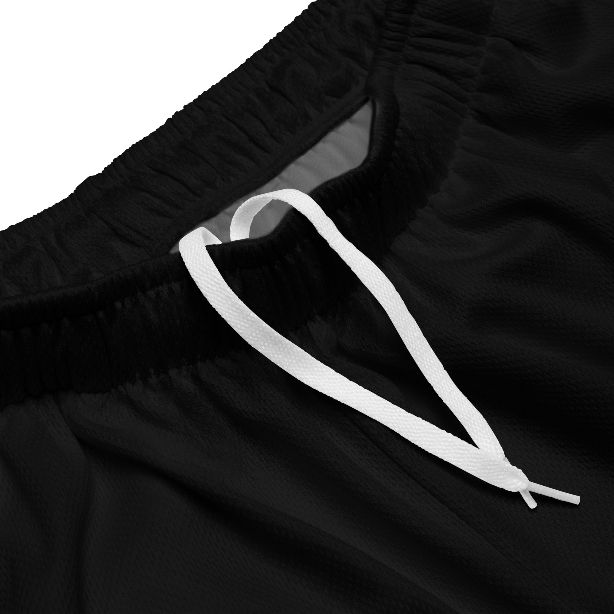 Schwarze Mesh-Sportshorts mit elastischem Bund. Am unteren rechten Bein steht in weißer Schrift mit rotem Schatten und schwarzem Rand das Wort "Nope".