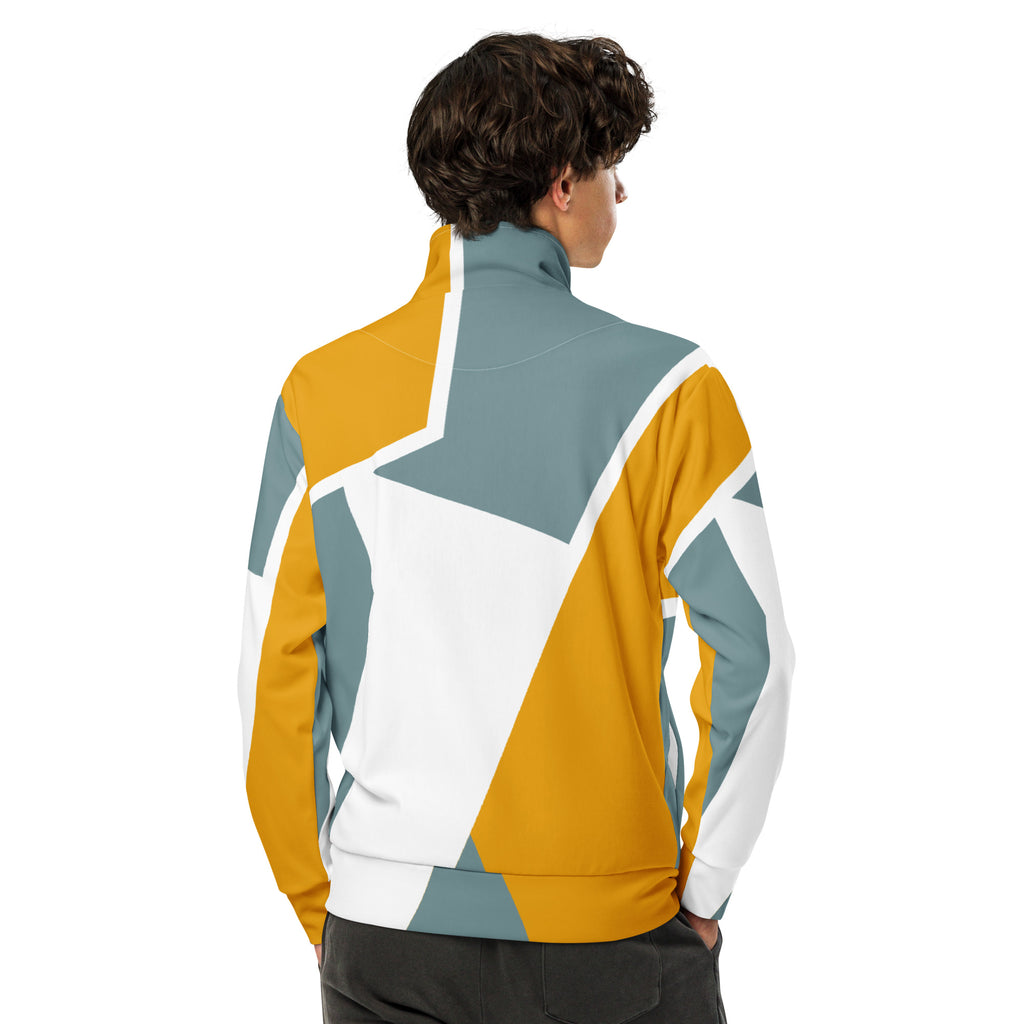 Trainingsjacke mit einem abstrakten, geometrischen Muster in den Farben Gelb, Grau und Weiß. Die Jacke hat einen Stehkragen und einen durchgehenden Reißverschluss.