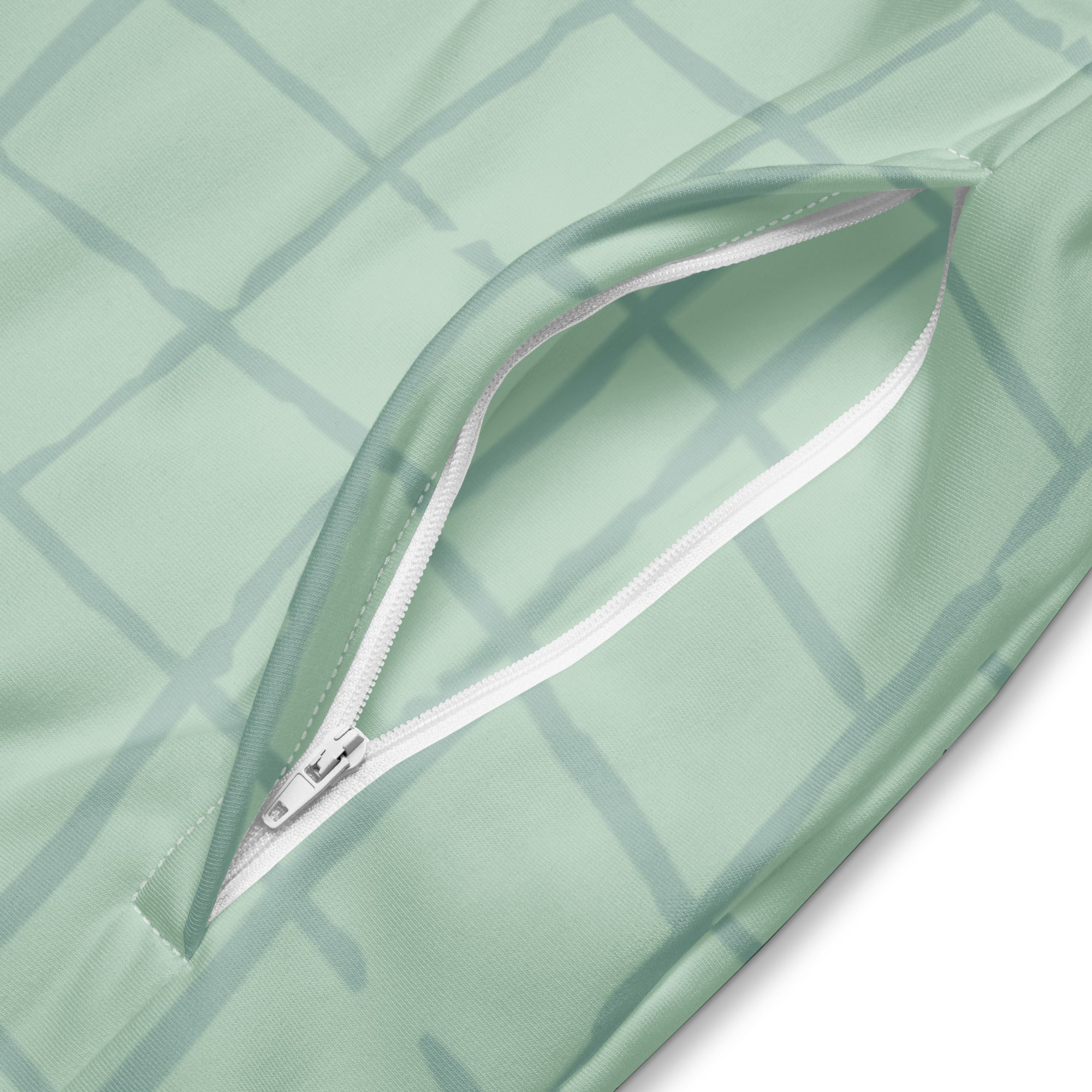 Trainingsjacke in hellem Mintgrün mit einem dezenten, hellgrauen Gittermuster. Die Jacke hat einen Stehkragen und einen durchgehenden Reißverschluss.