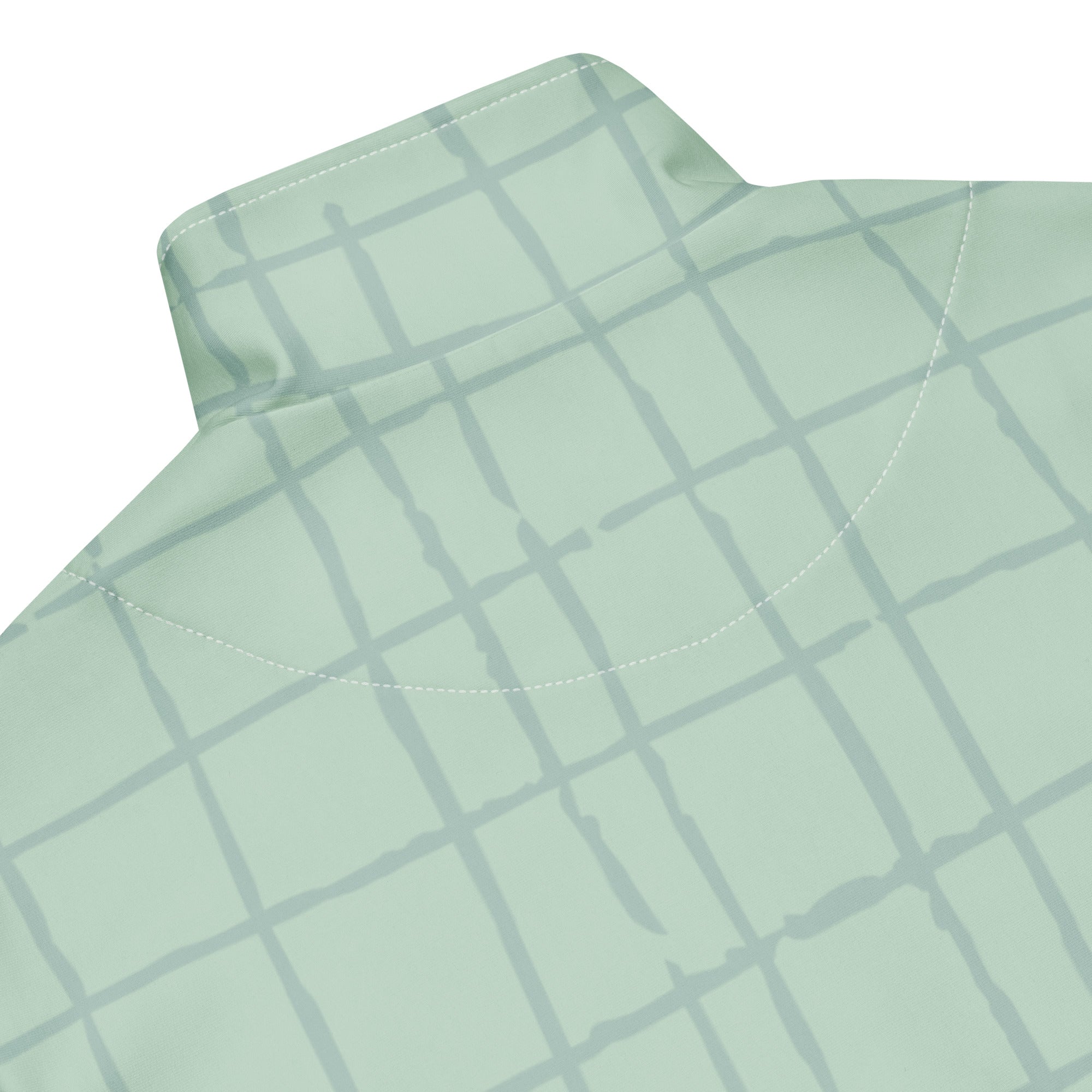 Trainingsjacke in hellem Mintgrün mit einem dezenten, hellgrauen Gittermuster. Die Jacke hat einen Stehkragen und einen durchgehenden Reißverschluss.