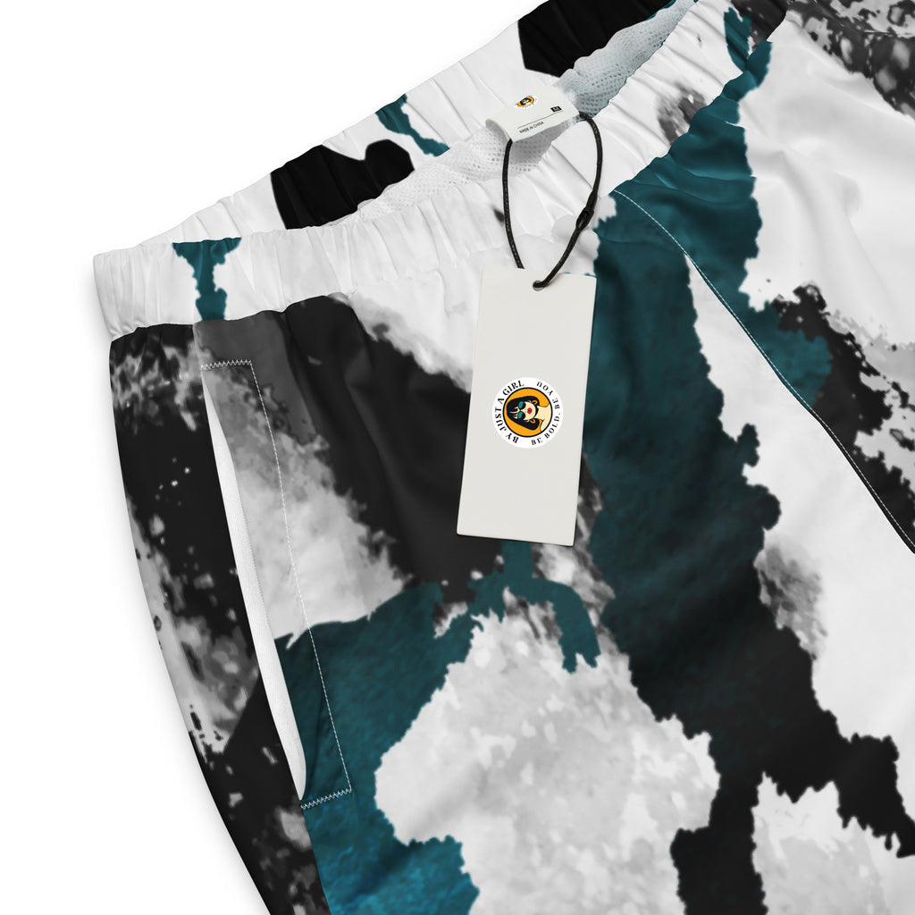 Herren-Trainingshose mit einem Inkstorm Muster in Schwarz, Grau, Türkis und Weiß. Die Hose hat einen elastischen Bund und Bündchen an den Beinabschlüssen.