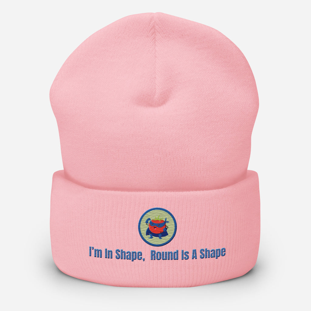Ein Baby rosanes Cuffed Beanie mit einem aufgesticktem Patch eines Tomaten Superhleden (Cartoon) in einem Runden blau-salbeigrünem Rahmen sowie einen schlichten Schriftzug darunter der lautet: "I´m in Shape, Round is A Shape!" auf der Vorderseite. Designed, by Just a Girl.