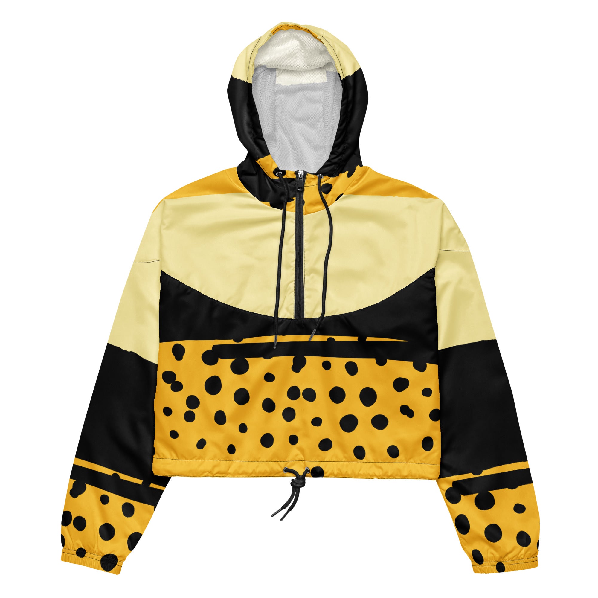Ein Damen Cropped Windbreaker in Gelb, Schwarz und einem pastell gelb, mit einem auffälligen schwarzen Punktemuster auf der unteren gelben Hälfte. Die Jacke hat eine Kapuze, einen halben Reißverschluss, schwarze Kordeln und einen verstellbaren Saum. 