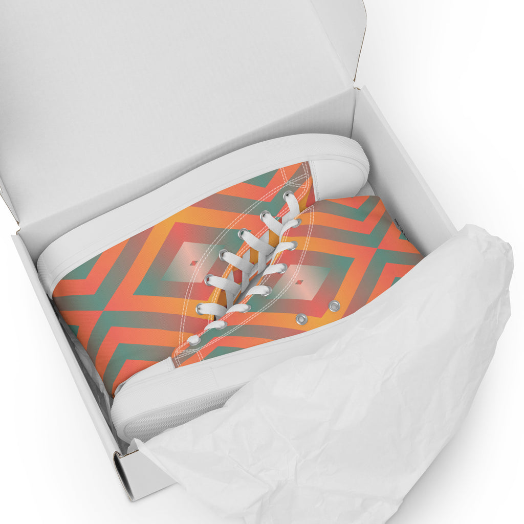 Ansicht liegend im Schuhkarton der weißen High-Top-Sneaker mit einem leuchtenden geometrischen Muster in Orange, Türkisgrün und Gelb. Die Schnürsenkel und Zehenkappen sind weiß. Designed, by Jsut a Girl.