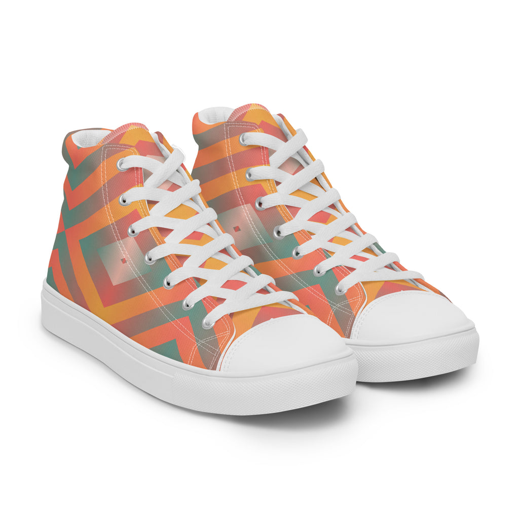 Ansicht von vorne der weißen High-Top-Sneaker mit einem leuchtenden geometrischen Muster in Orange, Türkisgrün und Gelb. Die Schnürsenkel und Zehenkappen sind weiß. Designed, by Just a Girl.