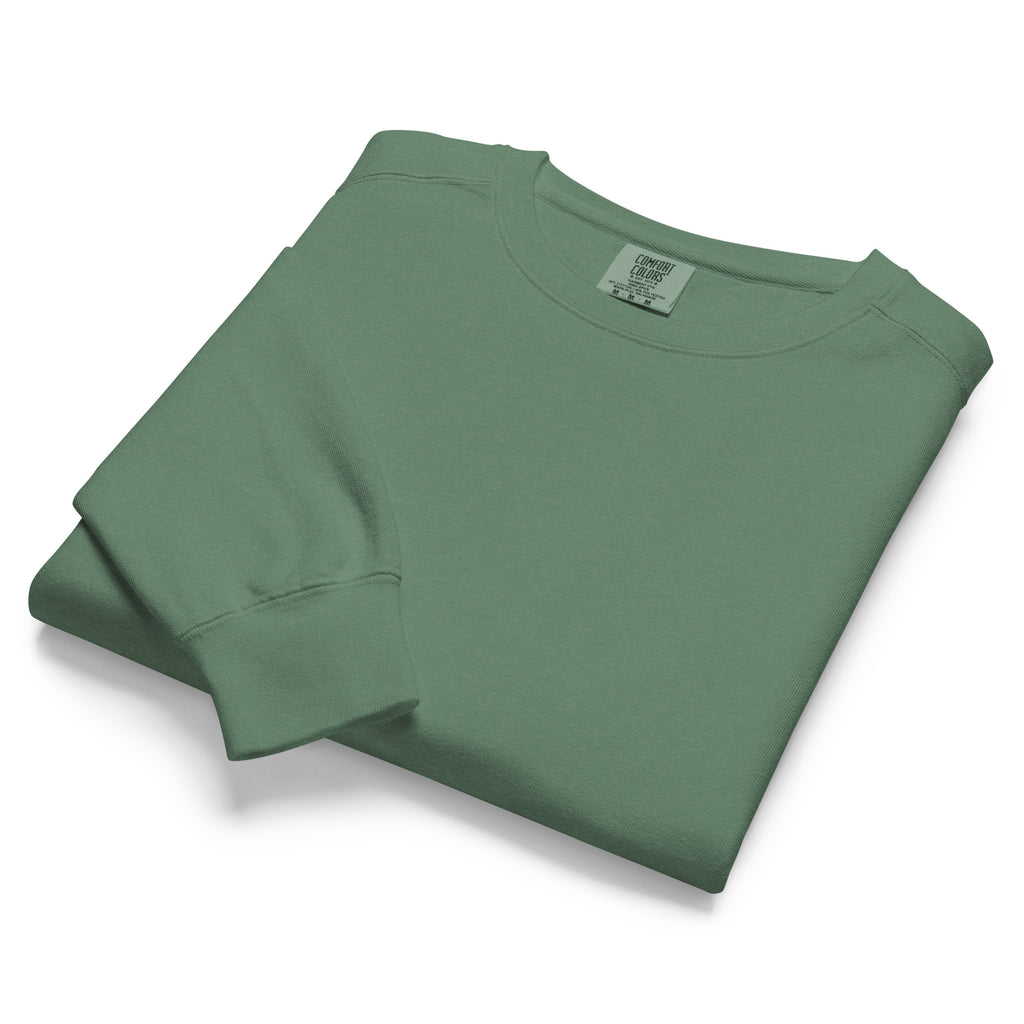 Ein unifarbener Pullover freigestellte gefaltete Ansicht in dunkelgrün, das als Pine Green  bezeichnet wird. Das Kleidungsstück ist schlicht und hat lange Ärmel.