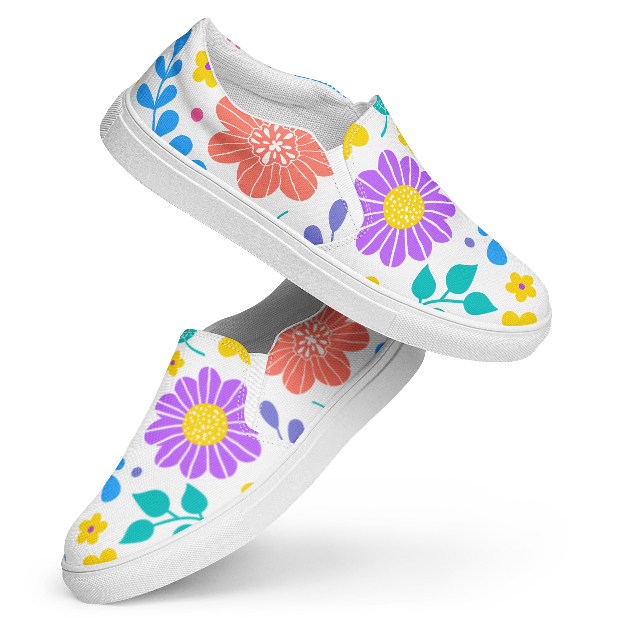 Ein Paar weiße Damen-Slip-on-Schuhe mit einem Muster aus bunten, stilisierten Blumen in Rot, Lila, Gelb, Grün und Blau. Die Schuhe schweben vor einem weißen Hintergrund. Designed, by Just a Girl.