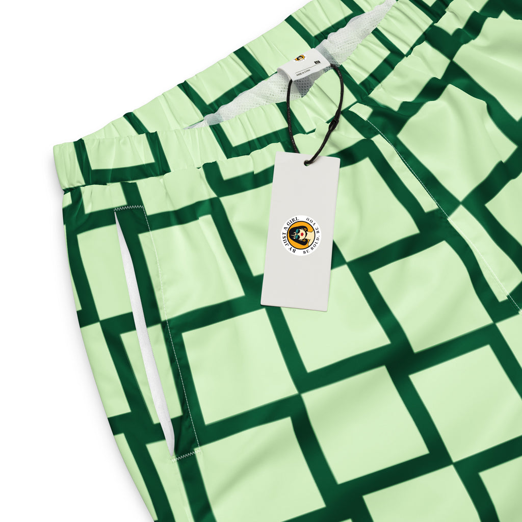 Eine Damen Trainingshose mit einem Schachbrettmuster in hellem Mintgrün und dunklem Grün. Hosenbund und Taschenansicht mit Logo vorne. By Just a Girl