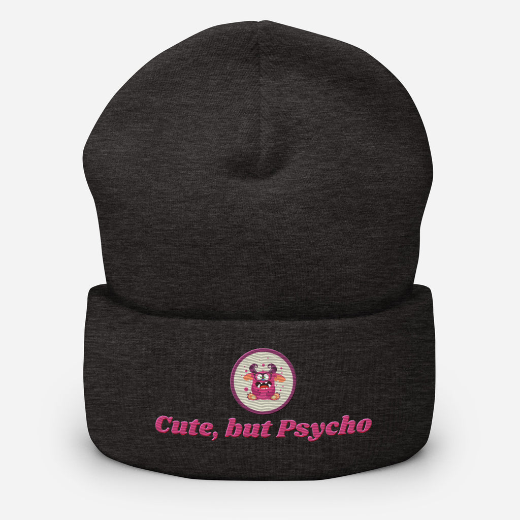 Eine Dunkelgraue Cuffed Beanie mit aufgesticktem pinken monster gesicht in einem runden lila Rahmen auf der Vorderseite und "Cute but Psycho" Schrift darunter. Designed, by Just a Girl.