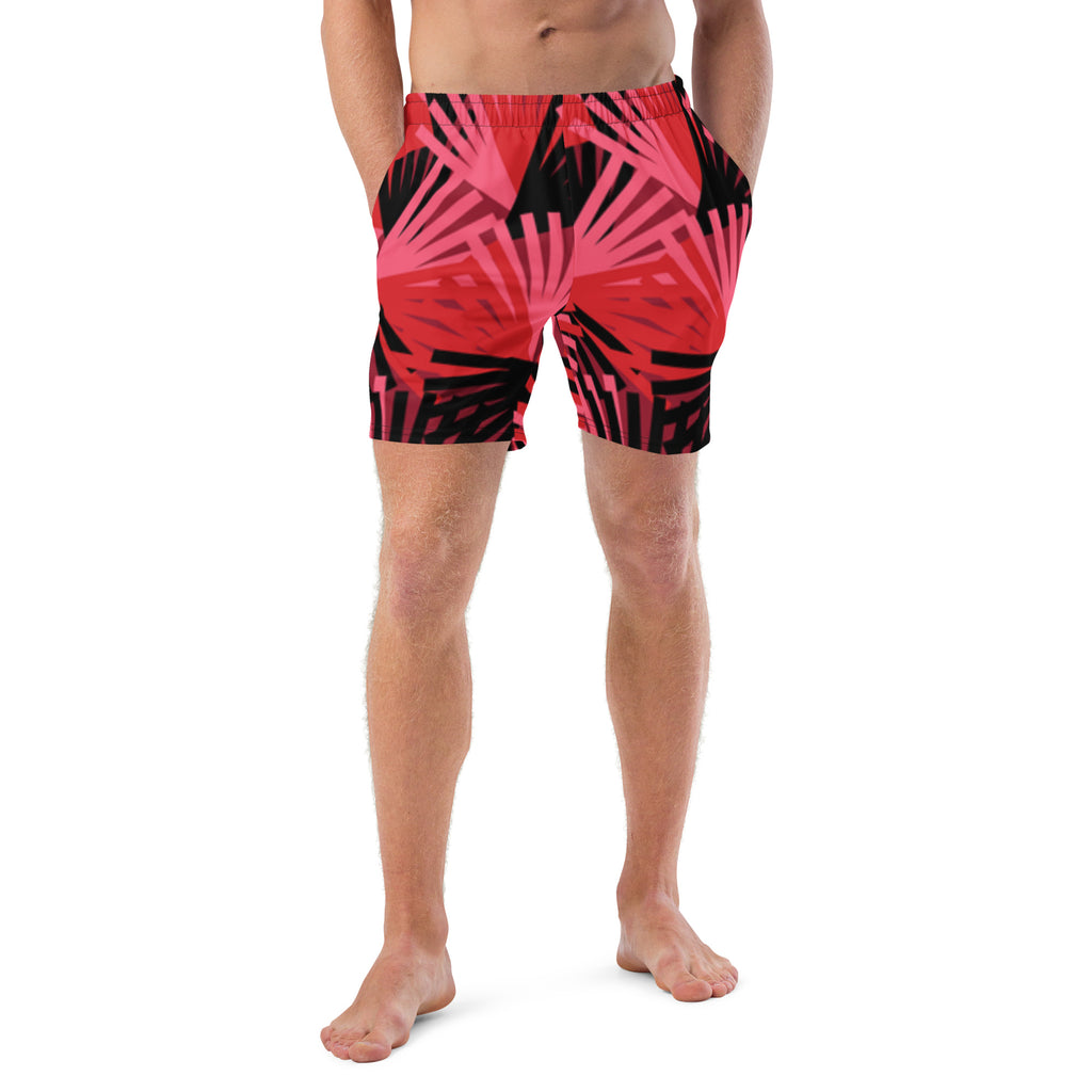 Eine Badeshorts mit einem Muster aus violetten Palmen und anderen stilisierten Pflanzen auf einem hellbeigen Hintergrund mit feinen, horizontalen Linien. Der Bund der Shorts ist elastisch.