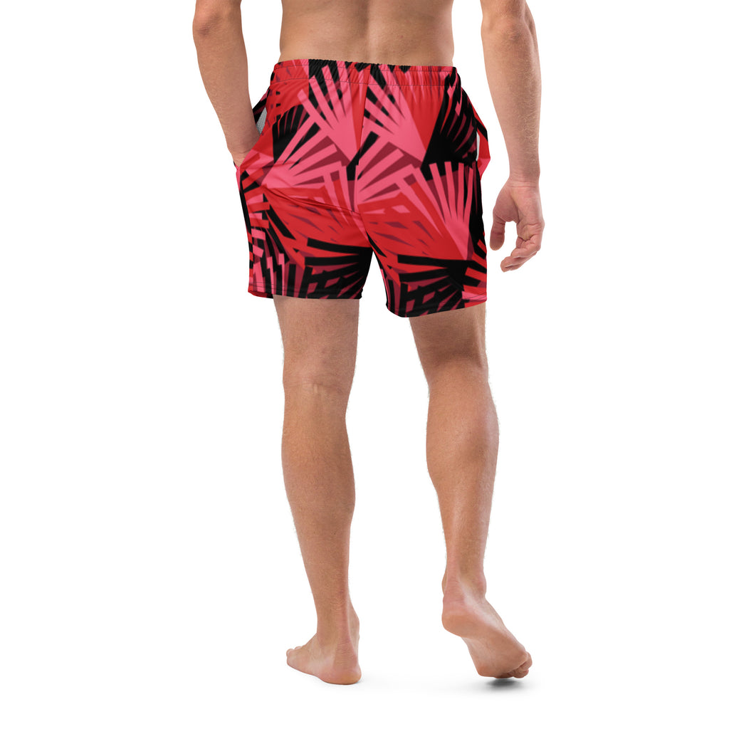 Eine Badeshorts mit einem Muster aus violetten Palmen und anderen stilisierten Pflanzen auf einem hellbeigen Hintergrund mit feinen, horizontalen Linien. Der Bund der Shorts ist elastisch.