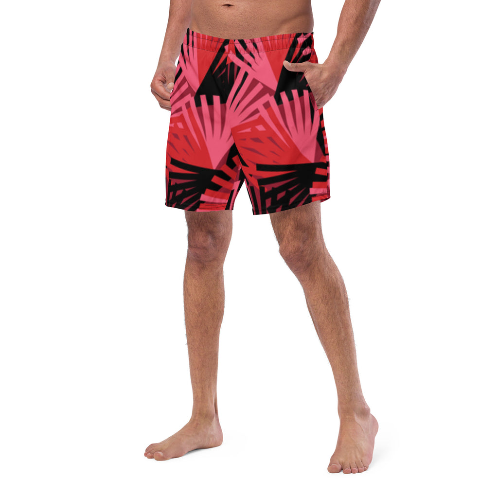 Eine Badeshorts mit einem Muster aus violetten Palmen und anderen stilisierten Pflanzen auf einem hellbeigen Hintergrund mit feinen, horizontalen Linien. Der Bund der Shorts ist elastisch.