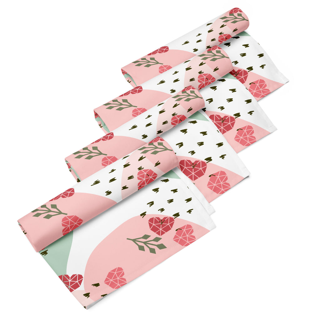 Ein Set aus vier gerollten Stoff-Servietten, freigestellt auf weißem Hintergrund. Der Hintergrund ist weiß und zeigt ein abstraktes Muster mit rosafarbenen Herzen, hellgrünen Blattformen und kleinen schwarzen Strichen.