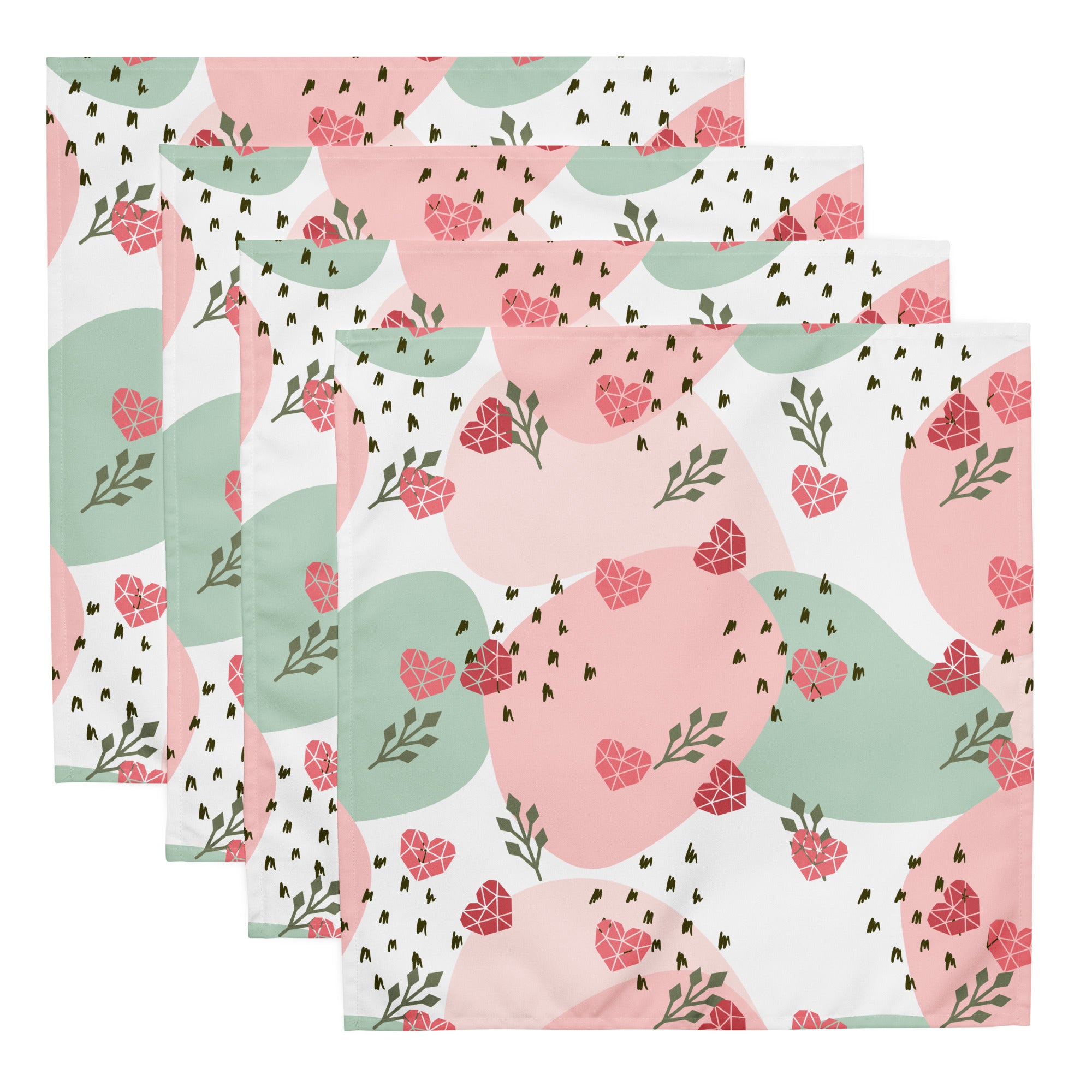 Ein Set aus vier Stoff-Servietten, freigestellt auf weißem Hintergrund. Der Hintergrund ist weiß und zeigt ein abstraktes Muster mit rosafarbenen Herzen, hellgrünen Blattformen und kleinen schwarzen Strichen.
